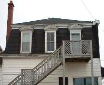 Original trim and dormer detail on mansard roof of the Kent Northern Hotel building.; Village of Rexton