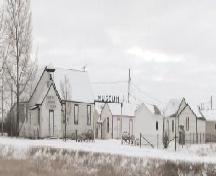 View of the entrance to the Prairie Pioneer Museum featuring several of the vernacular buildings located on the site, 2006.; Saskatchewan Architectural Heritage Society, Frank Korvemaker, 2006