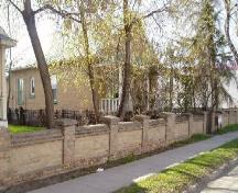 side view of the property showing the stone fence and trees, 2005.; Candice Lee, 2005.