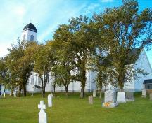 Notre Dame de l'Assomption side elevation and cemetery; Heritage Division, NS Dept. of Tourism, Culture and Heritage, 2004.