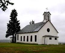 View of church with river valley in background.; Government of Saskatchewan, J. Bisson, 2003.