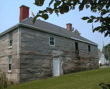 This rear elevation includes a door and three window openings on the second level.; PNB 2004