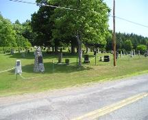 Bard John MacLean Cemetery, with Bard John Maclean's stone rubble monument in the foreground, Glen Bard, Nova Scotia, 2005.; Heritage Division, NS Dept. of Tourism, Culture and Heritage, 2005.