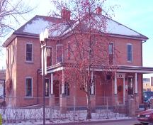 Exterior northeast view of the Parsons Residence from 49th Street, December 19, 2003, currently in use as a law practice office; City of Red Deer, 2003.