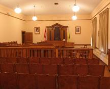 Interior image of the Shaunavon Courthouse highlighting the wood trim in the court room, 2006.; Government of Saskatchewan, Bernard Flaman, 2006.