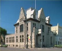 Corner view of the Portage La Prairie Public Building, showing two major facades, making use of its corner site, 1982.; Parks Canada Agency/Agence Parcs Canada, 1982.