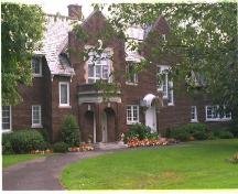 This Queen Anne Revival "house on the hill" was built 1911, and rebuilt after fire in 1944; City of Ottawa 2005