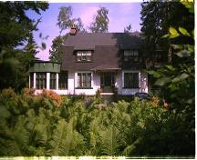 A charming, Victorian-style house of white stucco dates from about 1909.; City of Ottawa 2005