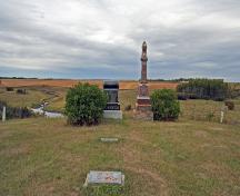 Contextual view, from the east, of the Thomas Greenway Cemetery, Crystal City, 2006. Thomas Greenway's modest in-ground marker lies between the grand stones at the back of the cemetery and the marker for his wife in the foreground.; Historic Resources Branch, Manitoba Culture, Heritage and Tourism, 2006