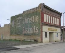 View of front and side elevations of Brite Spot featuring the painted adverstising on the south wall, 2004; Government of Saskatchewan, B. Dawson, 2004.