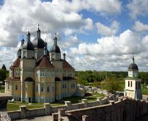 Context view, from the northwest, atop the adjacent grotto, of the Ukrainian Catholic Church of the Immaculate Conception, Cooks Creek, 2005; Historic Resources Branch, Manitoba Culture, Heritage, Tourism and Sport, 2005