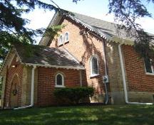Featured is the protruding, gable-roofed entranceway.; Kendra Green, 2007.