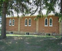 Of note are the symmetrically-placed paired lancet windows and brick buttresses.; Kendra Green, 2007.
