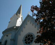This image presents two neo-Gothic features including a steep, bracketed gable and a large rose window above the entrance.; PNB 2005