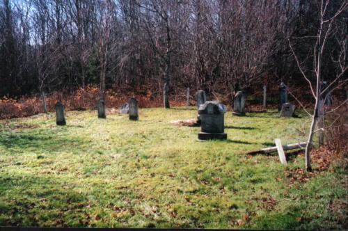 Showing context of cemetery near wooded area