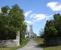 Drystone walls and vegetation frame the view of St. Mark's Anglican Church, Barriefield; RHI 2006