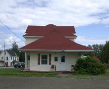 West side of the building with decorative side brackets supporting the wide overhang.; PNB 2005