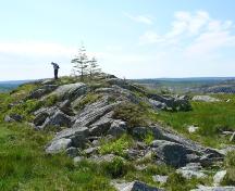 View of visitor standing atop Bulger, A Name Rock, searching for engraved names. Photo taken June, 2008; Deborah O'Rielly/ HFNL 2008
