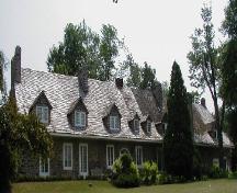 General view of Trestler House, showing the steeply pitched gable roof with dormers, extended eaves, and multiple chimneys, 2001.; Parks Canada Agency / Agence Parcs Canada, 2001.