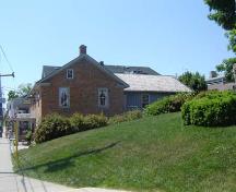 Featured are the low gabled roof and return eaves of the two-bay north elevation.; Kayla Jonas, 2007.