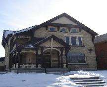 Of note is the extensive decoration on the porch gable and balcony.; Kayla Jonas, 2008.