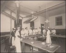 Women receiving cooking lessons in the basement of the library.; Reuben R. Sallows, (1855 – 1937), n.d.