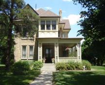 Of note are the second-storey enclosed porch and decorative pillars of the first-storey verandah.; Kayla Jonas, 2007.