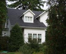 Of note is the steeply pitched gable roof and dormer window.; Paul Dubniak, 2009.