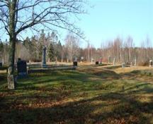The cemetery is on level gound with some plots terraced and fenced with low cement walls and iron railings; Grand Manan Historical Society