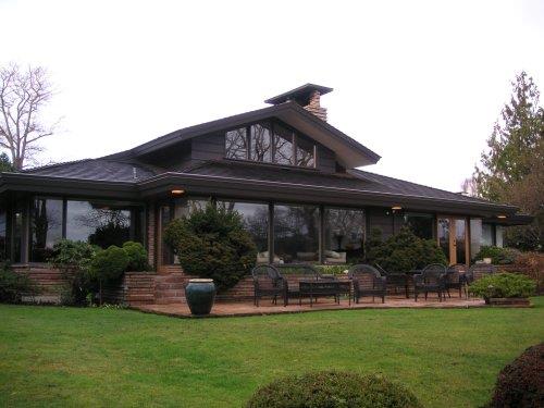 Rear view across lawn toward house and patio
