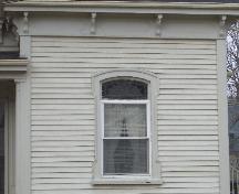 Architectural details:  decorative upper fanlight on window and under eave bracketing with pendants; City of Charlottetown, Natalie Munn, 2005