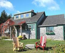 This image shows the main house of the Whale Cove Cottages where the dining hall is operated seasonally.  ; Whale Cove Cottages