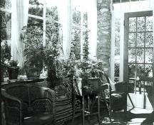 Interior view of the Jackman Residence, showing the interior sunroom, 1988.; Jasper National Park of Canada / Parc national du Canada Jasper, 1988.