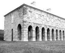Corner view of the Officers' Quarters, showing the symmetrical, regular composition, simple massing and balanced proportions of the building, 1989.; Canadian Parks Service / Service canadien des parcs, 1989.