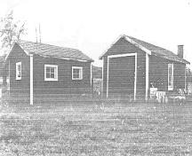 At left, general view of the Woodshed, showing the east and north façades, 1992.; Department of Public Works / Ministère des Travaux publics, (A & E Services -- CPS, WRO), 1992.