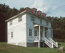 General view of Building 49, showing the two-storey massing with a hipped roof and dormers, circa 2004.; Parks Canada Agency / Agence Parcs Canada, circa/vers 2004.