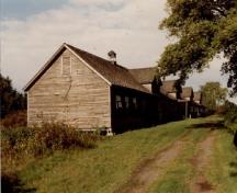 Corner view of Building 100, showing the four large dormers on the south slope of the roof.; Agence Parcs Canada / Parks Canada Agency