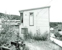 Rear façade of Harrington's Store (15), showing the wood frame construction, 1987.; Department of the Environment / Ministère de l'Environnement, 1987.
