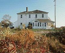 Façade of Building 38, showing the regular placement of the doors and the four pane windows, circa 2004.; Parks Canada Agency / Agence Parcs Canada, circa / vers 2004.
