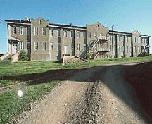 General view of Building 19, showing the exterior metal staircases, circa 2004.; Parks Canada Agency / Agence Parcs Canada, circa/vers 2004.