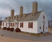 General view of the Officers' Quarters, showing its storey-and-a-half, gambrel-roofed, rectangular structure with a regularized plan, 1982.; (Canadian Parks Service, Atlantic Regional Office / Service canadien des parcs, Bureau régional de l'Atlantique, 1982.)