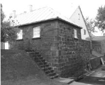 General view of Building 6, showing its small, rectangular, one-storey form with minimal ornamentation, 1991.; Rhona Goodspeed, Parks Canada Agency / Agence Parcs Canada, 1991.