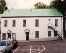 View of the exterior of Building 2, showing the two-storey massing with a sheet copper shed roof, 1993.; Parks Canada Agency / Agence Parcs Canada, Jocelyne Cossette, 1993.