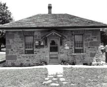 Façade of the Defensible Lockmaster's House, showing the simple compact, one-storey massing, 1989.; Parks Canada Agency / Agence Parcs Canada, Couture, 1989.