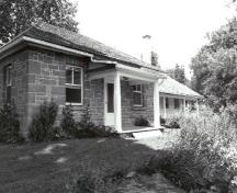 Façade of the Defensible Lockmaster's House, showing the simple, square, single-storey massing, 1989.; Parks Canada Agency / Agence Parcs Canada, Couture, 1989.