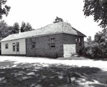 Rear view of the Defensible Lockmaster's House, showing the exterior walls of thick, evenly coursed masonry, 1989.; Parks Canada Agency / Agence Parcs Canada, Couture, 1989.