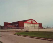 Hangar 11, montrant l'élévation ouest sur la droite et l'élévation nord sur la gauche. À l'extrême gauche, la section d'un étage qui a été ajouté à l'angle nord-ouest vers la fin des années 1950, début des années 1960 est visible, 2001.; Agence Parcs Canada / Parks Canada Agency, E. Tumak, 2001.