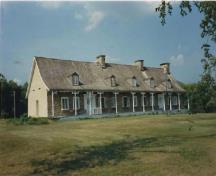 View of the house, showing the building’s basic massing and construction technology, representative of the early architecture of New France, 1991.; Agence Parcs Canada / Parks Canada Agency, 1991.