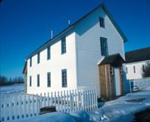 General view of the Saint-Antoine de Padoue Rectory emphasizing its simple, rectangular form and two storey massing of the functional structure, 1991.; Parks Canada Agency/Agence Parcs Canada, D. McArthur, 1991.