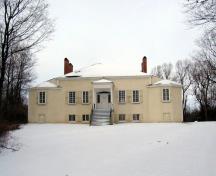 General view showing the building’s prominent site high on a natural rise above the St. Lawrence River in a picturesque wooded setting.; Parks Canada Agency / Agence Parcs Canada